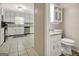 Bright, recently renovated bathroom with white cabinets and granite countertop, adjacent to kitchen at 110 Greenridge Ct, Fayetteville, GA 30215