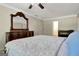 Spacious bedroom featuring a decorative mirror, a plush bed, and an ensuite bathroom at 110 Greenridge Ct, Fayetteville, GA 30215