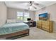 Bedroom featuring a bed, a desk with a computer, a TV, and hardwood furniture at 110 Greenridge Ct, Fayetteville, GA 30215