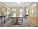 Light filled dining room with large table, complementary lamps, and neutral carpet at 110 Greenridge Ct, Fayetteville, GA 30215