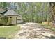 Large driveway that leads to an attached two car garage surrounded by mature trees at 110 Greenridge Ct, Fayetteville, GA 30215
