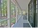 Spacious front porch with painted wood decking, detailed front door and scenic view of mature trees at 110 Greenridge Ct, Fayetteville, GA 30215