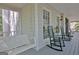 Spacious porch showcasing a porch swing and rocking chairs, perfect for enjoying the outdoors at 110 Greenridge Ct, Fayetteville, GA 30215