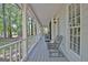 Inviting front porch with white railings, rocking chair, and view of the landscaped yard at 110 Greenridge Ct, Fayetteville, GA 30215