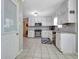 Updated kitchen with white cabinets, stainless steel appliances, and a mosaic backsplash, offering plenty of space at 110 Greenridge Ct, Fayetteville, GA 30215