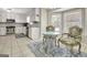 Open concept kitchen features breakfast nook, white cabinets, mosaic backsplash, and stainless steel appliances at 110 Greenridge Ct, Fayetteville, GA 30215