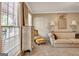 Bright living room featuring stylish furniture, neutral decor, and large window at 110 Greenridge Ct, Fayetteville, GA 30215