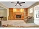 Bright living room showcasing brick fireplace with built-in shelving, plush carpeting, and comfortable seating at 110 Greenridge Ct, Fayetteville, GA 30215