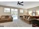 Spacious living room boasts neutral carpet, ceiling fan, and comfortable sofas with decorative pillows at 110 Greenridge Ct, Fayetteville, GA 30215