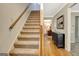 Bright staircase with carpeted steps and wooden banister leading to the upper level at 110 Greenridge Ct, Fayetteville, GA 30215