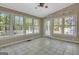 Bright sunroom with tiled floor and multiple windows offering peaceful views of the backyard at 110 Greenridge Ct, Fayetteville, GA 30215