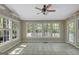 Light-filled sunroom boasts multiple windows providing beautiful views of the surrounding landscape at 110 Greenridge Ct, Fayetteville, GA 30215