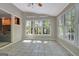 Beautiful sunroom with tiled floors and numerous windows leading to the living area at 110 Greenridge Ct, Fayetteville, GA 30215