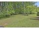 Green backyard surrounded by mature trees at 269 Malone Cir, Fairburn, GA 30213