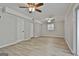 Spacious finished basement area with neutral walls, ceiling fans, light wood-look flooring and outdoor access at 269 Malone Cir, Fairburn, GA 30213