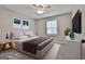 Staged bedroom with a queen bed, flatscreen TV, and grey walls at 269 Malone Cir, Fairburn, GA 30213