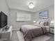 Staged bedroom with a queen bed, white rug, and flatscreen TV at 269 Malone Cir, Fairburn, GA 30213