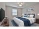 Comfortable bedroom with a ceiling fan, TV, large bed, and plenty of natural light at 269 Malone Cir, Fairburn, GA 30213