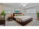 Staged bedroom with a queen bed, ceiling fan, and two windows at 269 Malone Cir, Fairburn, GA 30213