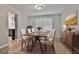 Formal dining room with a table and chairs set on an area rug in a room with grey walls and new flooring at 269 Malone Cir, Fairburn, GA 30213