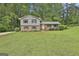 Charming two-story home with a well-manicured lawn and beautiful landscaping at 269 Malone Cir, Fairburn, GA 30213