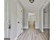 Light-filled foyer featuring fresh gray paint, new laminate flooring, and views to the kitchen and living room at 269 Malone Cir, Fairburn, GA 30213