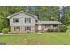 Exterior shot of front brick house with gray siding, black shutters, and landscaped yard at 269 Malone Cir, Fairburn, GA 30213