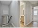 Hallway with a view of the bathroom, stairs, and bedrooms, with vinyl flooring at 269 Malone Cir, Fairburn, GA 30213