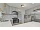 Modern kitchen with stainless steel appliances, light gray cabinets, mosaic backsplash, and bright countertops at 269 Malone Cir, Fairburn, GA 30213