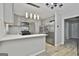 Updated kitchen with stainless steel appliances, gray cabinets, quartz countertops and light fixture above island at 269 Malone Cir, Fairburn, GA 30213