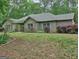 Charming brick home with a well-manicured lawn and lush landscaping at 678 Oak Grove Rd, Mcdonough, GA 30253