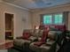 Comfortable bedroom with large window offering ample natural light and a sitting area at 678 Oak Grove Rd, Mcdonough, GA 30253