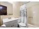 Bathroom features a white toilet, sink, and shower with a decorative shower curtain at 812 Bartow Ct, Riverdale, GA 30274