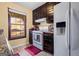 The kitchen features dark wood cabinets, white appliances and views of the neighborhood at 812 Bartow Ct, Riverdale, GA 30274