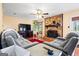 Cozy living room with stone fireplace, hardwood floors, and comfortable seating at 812 Bartow Ct, Riverdale, GA 30274