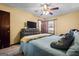 Comfortable bedroom featuring a large bed, dresser with TV, and a window view at 812 Bartow Ct, Riverdale, GA 30274