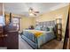 Well-lit bedroom featuring a large bed with lamps, dresser, and neutral tones at 812 Bartow Ct, Riverdale, GA 30274