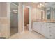 Well-lit bathroom featuring double vanity, granite countertops, and tiled shower at 140 Campaign Trl, Fayetteville, GA 30214