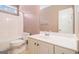 Bathroom with vanity, white fixtures, and shower-tub combination beneath a bright window at 140 Campaign Trl, Fayetteville, GA 30214