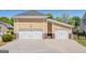 Three-car garage with white doors and spacious driveway at 140 Campaign Trl, Fayetteville, GA 30214