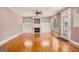 Bright living room with a fireplace and built-in shelves, featuring hardwood floors at 140 Campaign Trl, Fayetteville, GA 30214