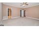 Spacious main bedroom with plush carpeting and ensuite bathroom and closet entrances at 140 Campaign Trl, Fayetteville, GA 30214