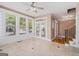 Bright sunroom with tile flooring, ceiling fan and access to the outdoors through French doors at 140 Campaign Trl, Fayetteville, GA 30214