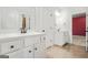 Bright bathroom featuring dual vanities with white cabinets, modern fixtures, and neutral tile flooring at 130 Sycamore Row, South Fulton, GA 30331
