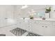 Elegant bathroom featuring dual sinks, white cabinets, decorative mirrors, and stylish lighting at 130 Sycamore Row, South Fulton, GA 30331