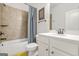 Neutral bathroom with a tile shower-tub, updated vanity, and decoratively-framed artwork at 130 Sycamore Row, South Fulton, GA 30331