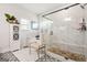 Modern bathroom with a soaking tub, walk-in shower, marble tile, and chic decor at 130 Sycamore Row, South Fulton, GA 30331