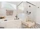 Bathroom featuring a soaking tub, glass-enclosed shower, and stylish fixtures at 130 Sycamore Row, South Fulton, GA 30331