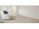 A bedroom with neutral-toned carpet, a comfy armchair, and an ensuite bathroom at 130 Sycamore Row, South Fulton, GA 30331
