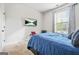 Cozy bedroom with a modern TV, a comfortable bed, and a bright window at 130 Sycamore Row, South Fulton, GA 30331